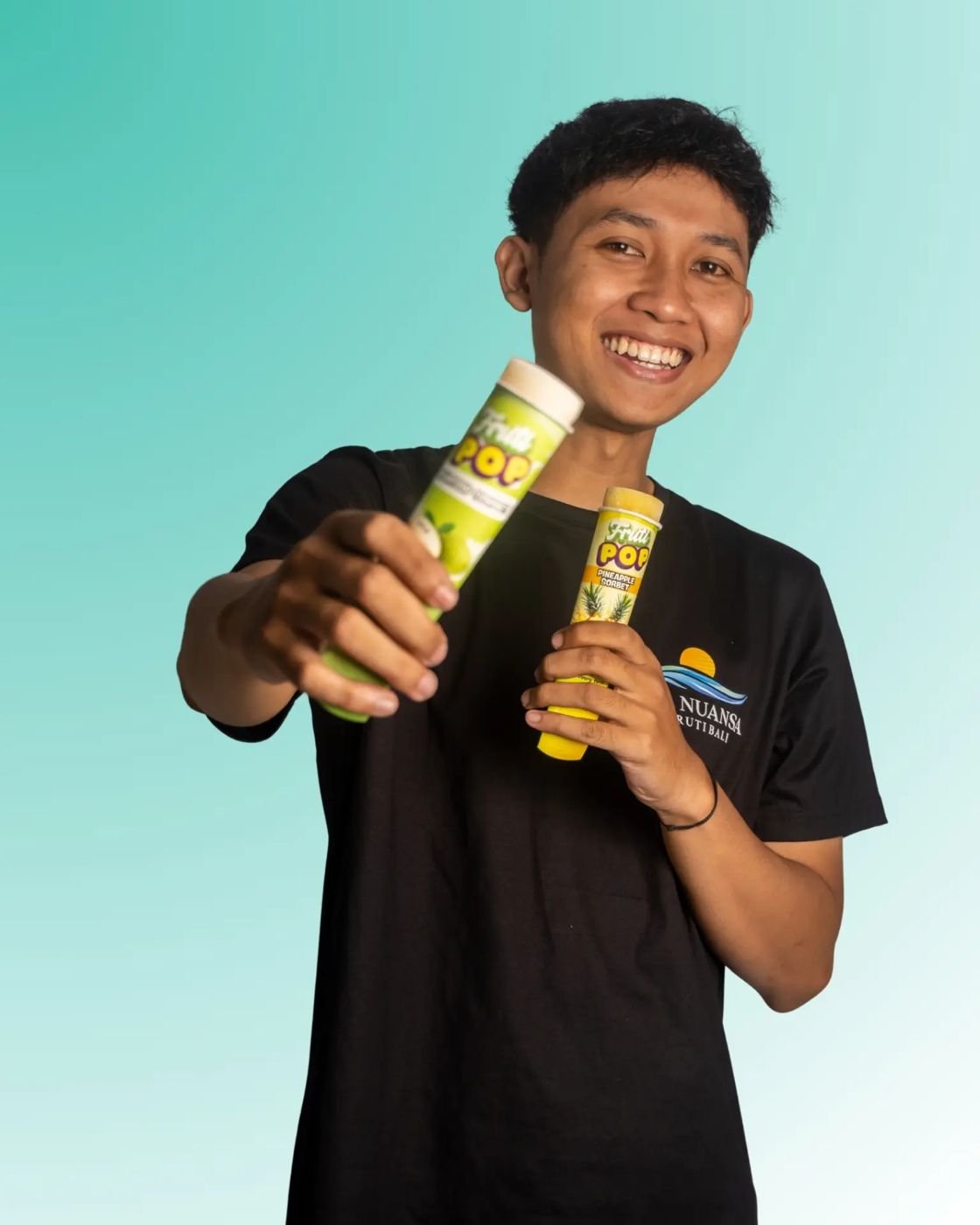 Fruti Pop team member holding two pops